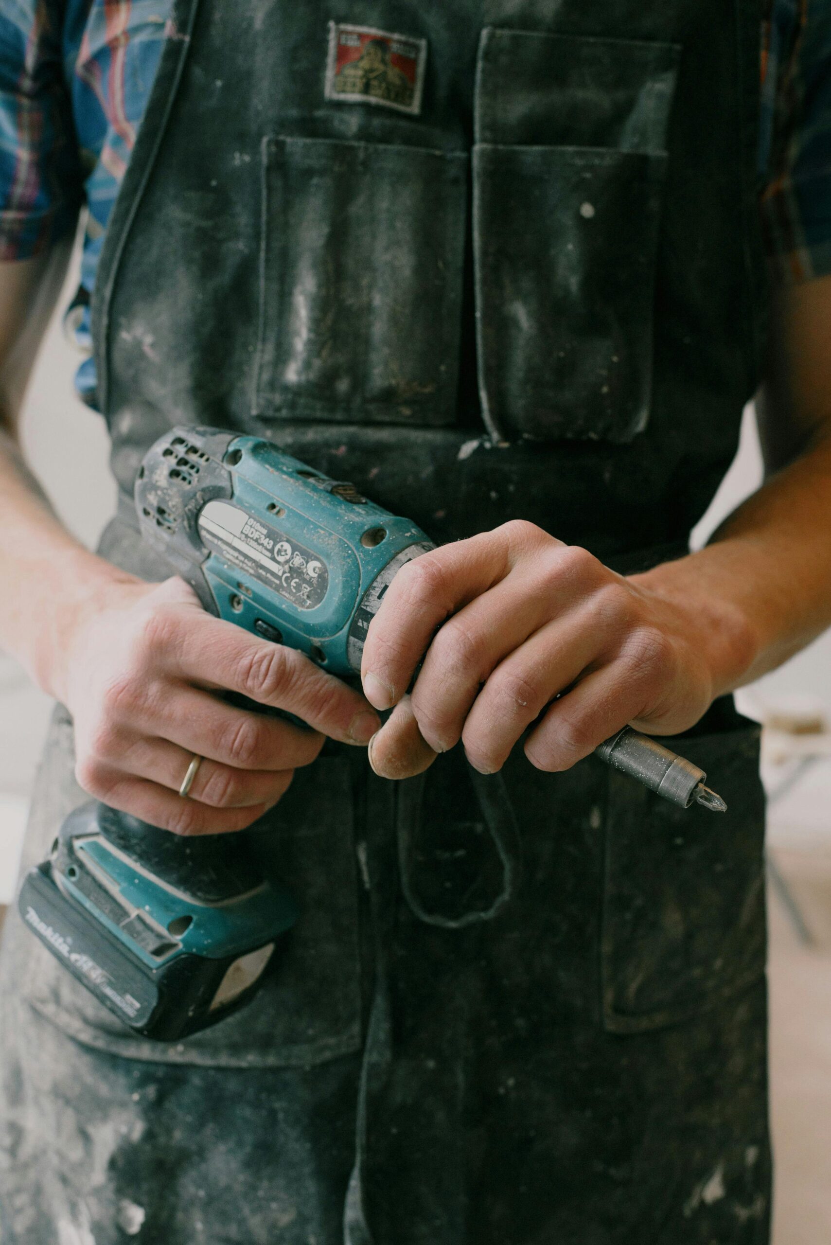 A person holding a drill